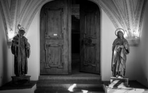 Church entrance flanked by two sculptures of saints Church entrance flanked by two sculptures of saints