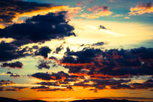 Cloudy sky with setting sun, play of colours, thunderclouds Cloudy sky with setting sun, play of colours, thunderclouds