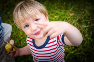 Toddler, two-year-old with red and white striped tee, cheeky, facing camera Toddler, two-year-old with red and white striped tee, cheeky, facing camera
