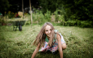 Girl with long brown hair, laughing, facing camera Girl with long brown hair, laughing, facing camera