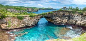 Rock coastline of Nusa Penida. Stone arch over the sea. Broken beach, Nusa Penida,Indonesia Rock coastline of Nusa Penida. Stone arch over the sea. Broken beach, Nusa Penida,Indonesia