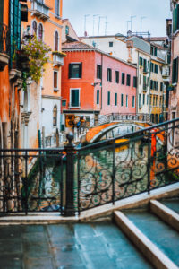 Venice, Italy. The bridge and the colored houses on the shore of a narrow channel. Venice, Italy. The bridge and the colored houses on the shore of a narrow channel.