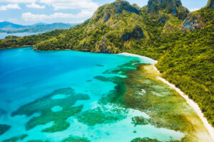 Cadlao lagoon, El Nido, Palawan Island, Philippines. Aerial drone view of a tropical island coastline, coral reef, jungle. Cadlao lagoon, El Nido, Palawan Island, Philippines. Aerial drone view of a tropical island coastline, coral reef, jungle.