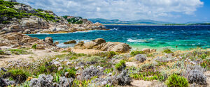 Costline of Costa Serena with sandstone rocks and sea waves, Sardinia, Italy.