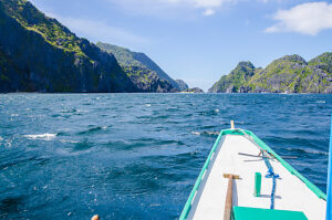 Banca Boat approaching Mantiloc Island on Windy Day, El, Nido, Palawan, Philippines