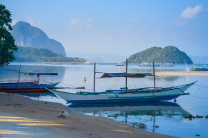 Traditional banca boat at sandy Corong Beach in El Nido, Philippines.