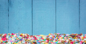Blue wooden background with confetti Blue wooden background with confetti