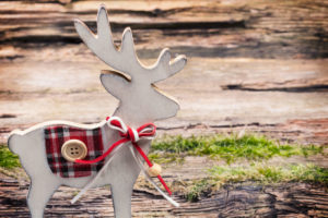 Christmas decoration, reindeer in front of wooden background Christmas decoration, reindeer in front of wooden background