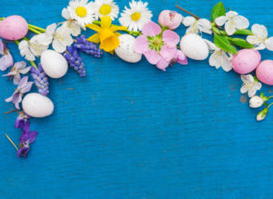 Easter eggs and flowers on blue wood, easter decoration with copy space Easter eggs and flowers on blue wood, easter decoration with copy space
