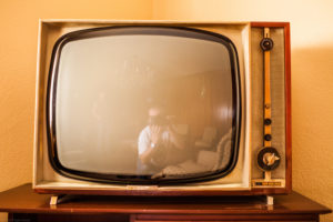 Vintage TV in an old fashioned hotel room, Guadalara, Spain with reflection of photographer