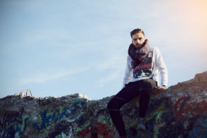 Young man sits on a wall Young man sits on a wall
