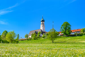 Germany, Bavaria, Tölzer Land, Isarwinkel, Gaißach, Spring meadow with St. Michael's Church