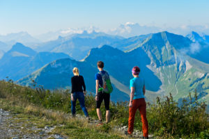 Three hikers in the Moleson hiking area, Moléson-sur-Gruyères, Canton of Friborg, Switzerland Three hikers in the Moleson hiking area, Moléson-sur-Gruyères, Canton of Friborg, Switzerland
