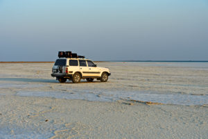 4x4 vehicle of a local tourism company stands on the salt crust of the Assale Salt Lake, Hamedala, Danakil Valley, Afar Region, Ethiopia 4x4 vehicle of a local tourism company stands on the salt crust of the Assale Salt Lake, Hamedala, Danakil Valley, Afar Region, Ethiopia