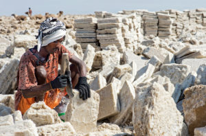 Local man cuts blocks of salt in a salt quarry at Assale Salt Lake, Danakil Depression, Afar Region, Ethiopia Local man cuts blocks of salt in a salt quarry at Assale Salt Lake, Danakil Depression, Afar Region, Ethiopia