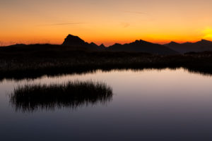 Glowing sky, morning mood at a mountain lake, alpenglow Glowing sky, morning mood at a mountain lake, alpenglow