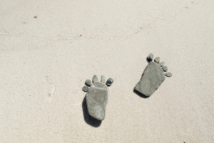 Footprints made of flat stones on the beach, Footprints made of flat stones on the beach,