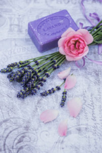 Florale decoration, pink rose on lavender, lavender soap, single petals in the foreground Florale decoration, pink rose on lavender, lavender soap, single petals in the foreground