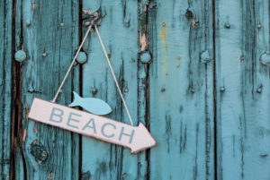 Arrow direction Beach on old turquoise wooden board, maritime decoration, Arrow direction Beach on old turquoise wooden board, maritime decoration,