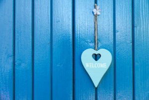 Turquoise heart with saying 'Welcome' on a blue door Turquoise heart with saying 'Welcome' on a blue door
