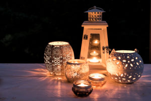Different lanterns and lights are lightning on white wooden board in the darkness, Different lanterns and lights are lightning on white wooden board in the darkness,