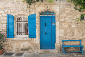 Wall of a house made of natural stone, window, blue shutters, door and bench in the South of France, Wall of a house made of natural stone, window, blue shutters, door and bench in the South of France,
