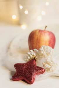 Christmas Still Life with Red Star, cones and apple, the background glittering lights, Christmas Still Life with Red Star, cones and apple, the background glittering lights,