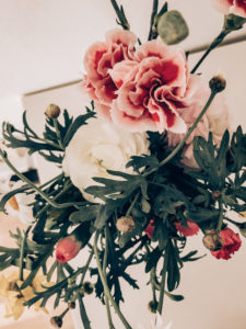 Spring bouquet with carnations and ranunculus, colorful bouquet in a white vase, Instagram style, dark processing Spring bouquet with carnations and ranunculus, colorful bouquet in a white vase, Instagram style, dark processing