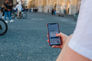Red-haired woman with Corona warning app on Odeonsplatz in Munich / Instructions for Corona warning app Red-haired woman with Corona warning app on Odeonsplatz in Munich / Instructions for Corona warning app