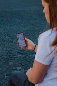 Red-haired woman with Corona warning app on Odeonsplatz in Munich / Instructions for Corona warning app Red-haired woman with Corona warning app on Odeonsplatz in Munich / Instructions for Corona warning app