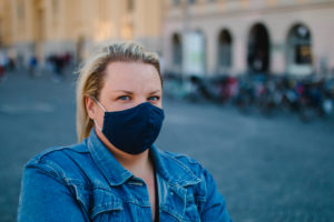 Blond woman with mask in Corona times on full Odeonsplatz in Munich Blond woman with mask in Corona times on full Odeonsplatz in Munich