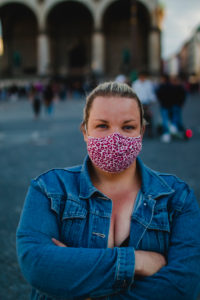 Blond woman with mask in Corona times on full Odeonsplatz in Munich Blond woman with mask in Corona times on full Odeonsplatz in Munich