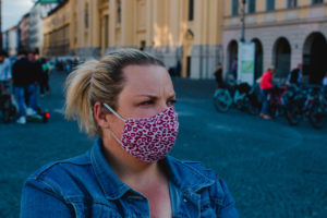 Blond woman with mask in Corona times on full Odeonsplatz in Munich Blond woman with mask in Corona times on full Odeonsplatz in Munich