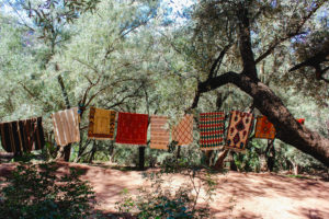 Berber carpets in forest in Ouzoud on clothesline Berber carpets in forest in Ouzoud on clothesline
