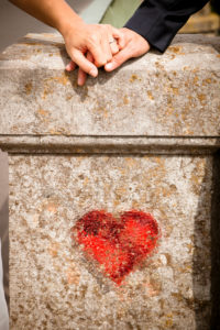 Detail, wedding, couple, holding hands with graffiti heart Detail, wedding, couple, holding hands with graffiti heart