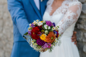 Detailed view, wedding, bridal couple holding bouquet of flowers in camera Detailed view, wedding, bridal couple holding bouquet of flowers in camera
