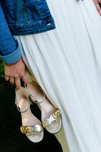 Detail, wedding, bride, casual with jeans jacket and shoes in hand Detail, wedding, bride, casual with jeans jacket and shoes in hand