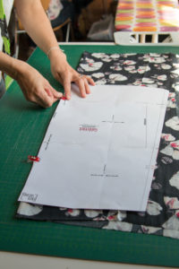 Detail view of fabrics at a sewing workshop Woman cutting fabric Detail view of fabrics at a sewing workshop Woman cutting fabric