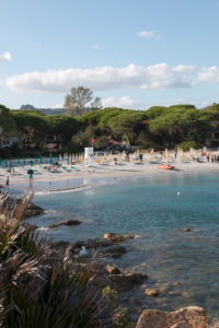 Beach section in Sardinia, private beach of a hotel complex with deck chairs and tourists Beach section in Sardinia, private beach of a hotel complex with deck chairs and tourists