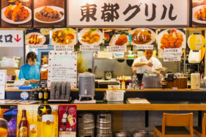 Japan, Honshu, Tokyo, Tsukiji, Tsukiji Outer Market, Seafood Restaurant with Customers Sitting at the Counter Japan, Honshu, Tokyo, Tsukiji, Tsukiji Outer Market, Seafood Restaurant with Customers Sitting at the Counter