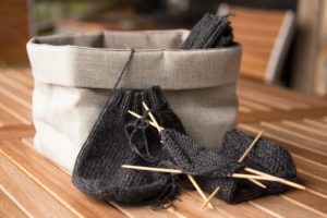 Knitting socks with wooden knitting needles in process Knitting socks with wooden knitting needles in process
