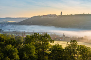View of Freyburg with Neuenburg Castle, in front the church of Nißmitz, morning fog in the Unstrut valley, Freyburg (Unstrut), Saxony-Anhalt, Germany View of Freyburg with Neuenburg Castle, in front the church of Nißmitz, morning fog in the Unstrut valley, Freyburg (Unstrut), Saxony-Anhalt, Germany
