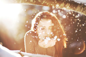 Portrait of a young woman in the snow in backlight Portrait of a young woman in the snow in backlight