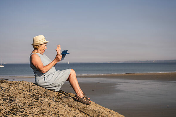 Young woman practicing yoga on the beach, doing crane pose