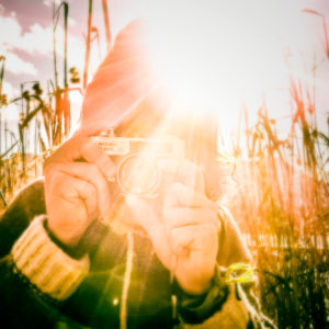 Austria, Mondsee, man taking pictures with analog camera