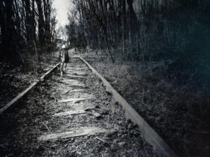 Man walking on deserted tracks