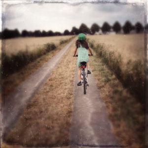 girl with bike on field path