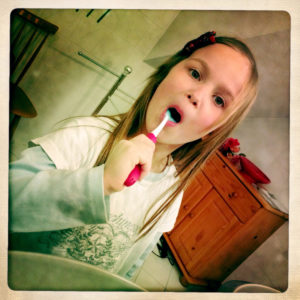 Girl brushing her teeth, dental hygiene