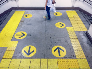 Japan, yellow arrow signs at metro station