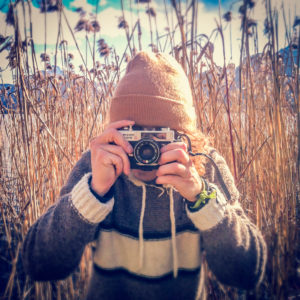 Austria, Mondsee, man taking pictures with analog camera